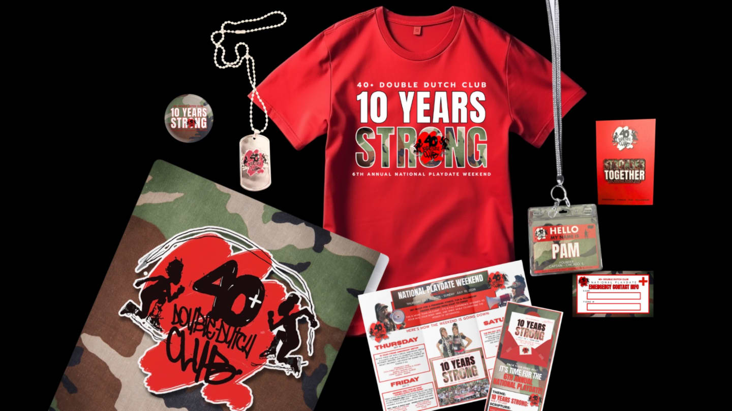 10 Years Strong Playdate package — red National Playdate T-shirt, dog-tag lanyard, camo notebook, emergency contact card, and weekend itinerary